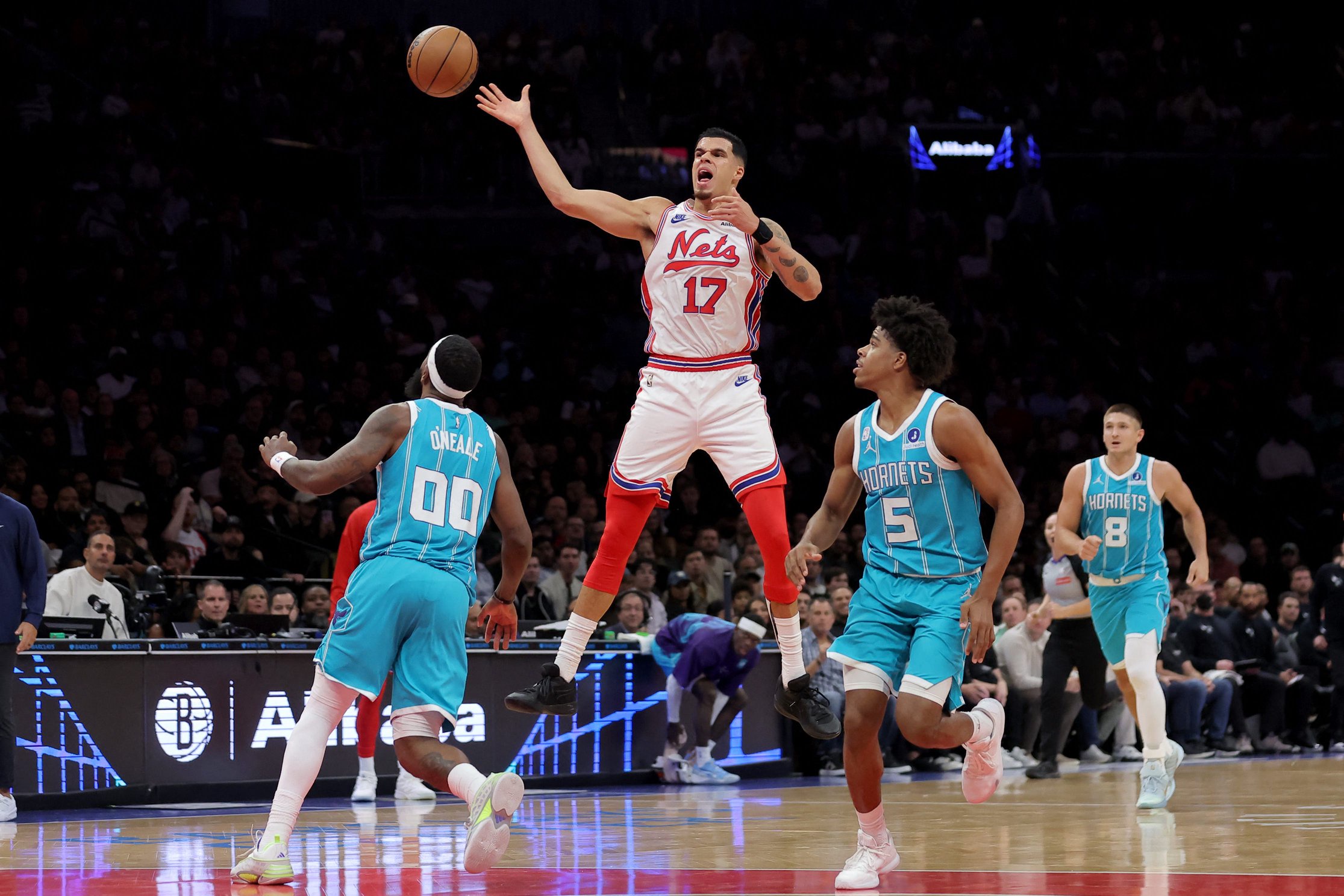 Oct 21, 2026; Brooklyn, New York, USA; Brooklyn Nets forward Michael Porter Jr. (17) fights for a loose ball against Charlotte Hornets forward Royce O'Neale (00) and guards Christian Anderson (5) and Grayson Allen (8) during the third quarter at Barclays Center. Mandatory Credit: Brad Penner-Imagn Images