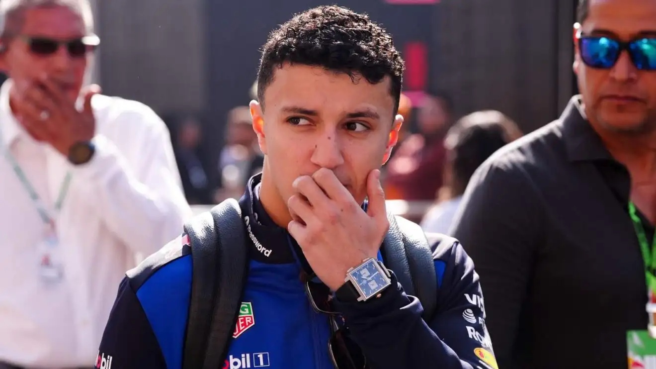 Red Bull driver Isack Hadjar with his hand covering his mouth.