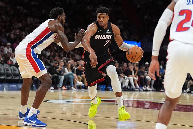 Miami Heat forward Giannis Antetokounmpo (7) pushes past Detroit Pistons forward Paul Reed during the second half of an NBA basketball game, Friday, Oct. 23, 2026, in Miami. (AP Photo/Rebecca Blackwell)