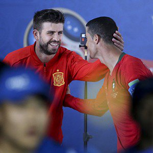 Gerardo Piqué - SOCHI, RUSSIA - JUNE 15: Gerard Pique of Spain greets Cristiano Ronaldo of Portugal in the corridor leading to the pitch before the 2018 FIFA World Cup Russia group B match between Portugal and Spain at Fisht Stadium on June 15, 2018 in Sochi, Russia. (Photo by Jean Catuffe/Getty Images)