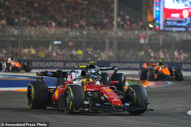 Ferrari driver Lewis Hamilton of Britain steers his car during the Singapore Formula One Grand Prix race in Singapore, Sunday, Oct. 11, 2026. (AP Photo/Vincent Thian)