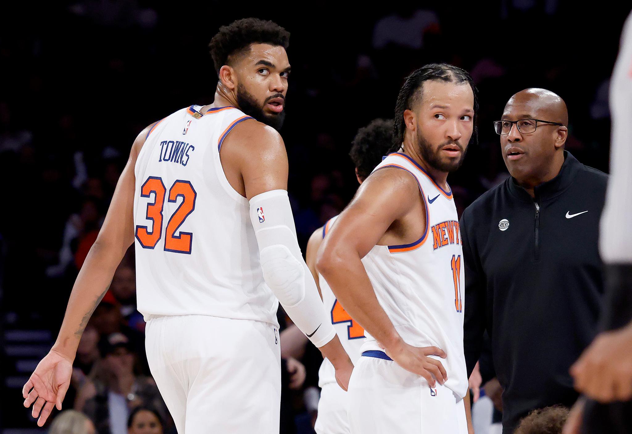 New York Knicks center Karl-Anthony Towns and guard Jalen Brunson react to a call alongside their coach during a game against the Toronto Raptors.