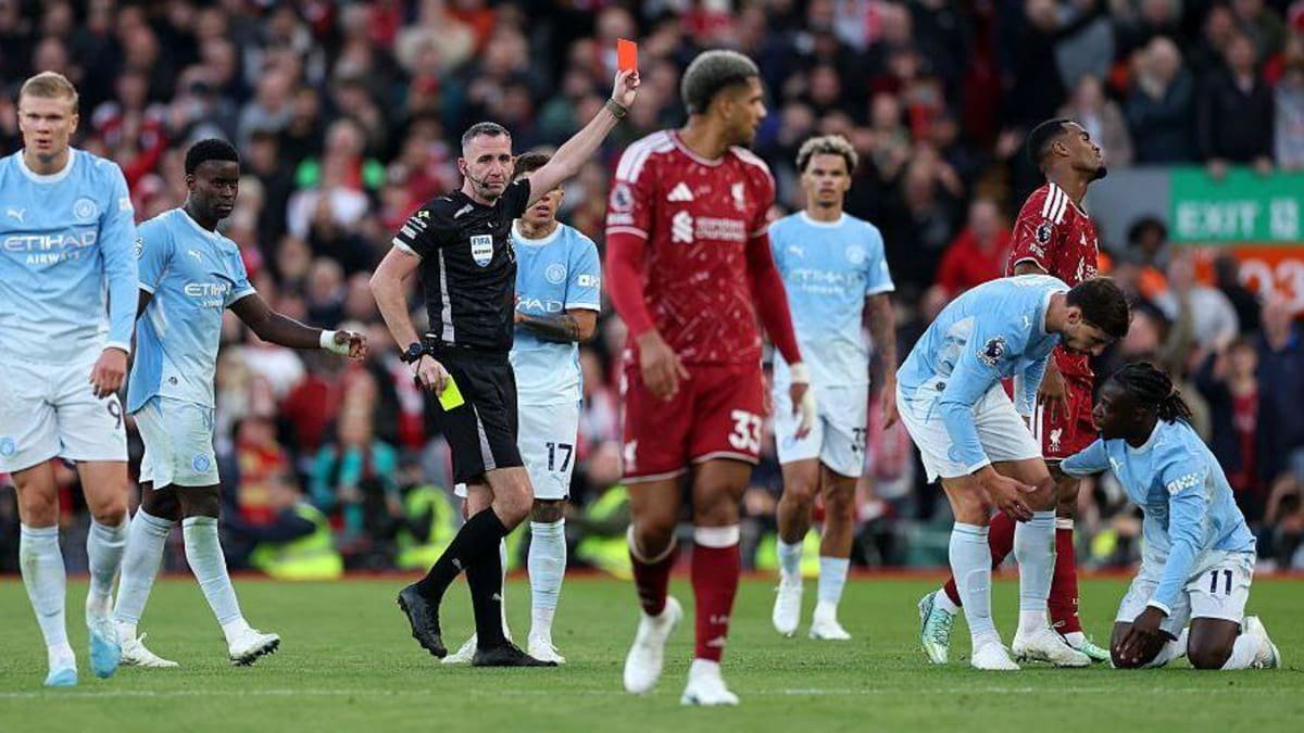 Ryan Gravenberch of Liverpool receives a red card from referee Chris Kavanagh after getting a second yellow card