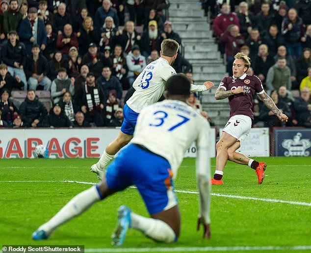 The defender watches on as Calvin Miller fires Hearts in front on Wednesday night