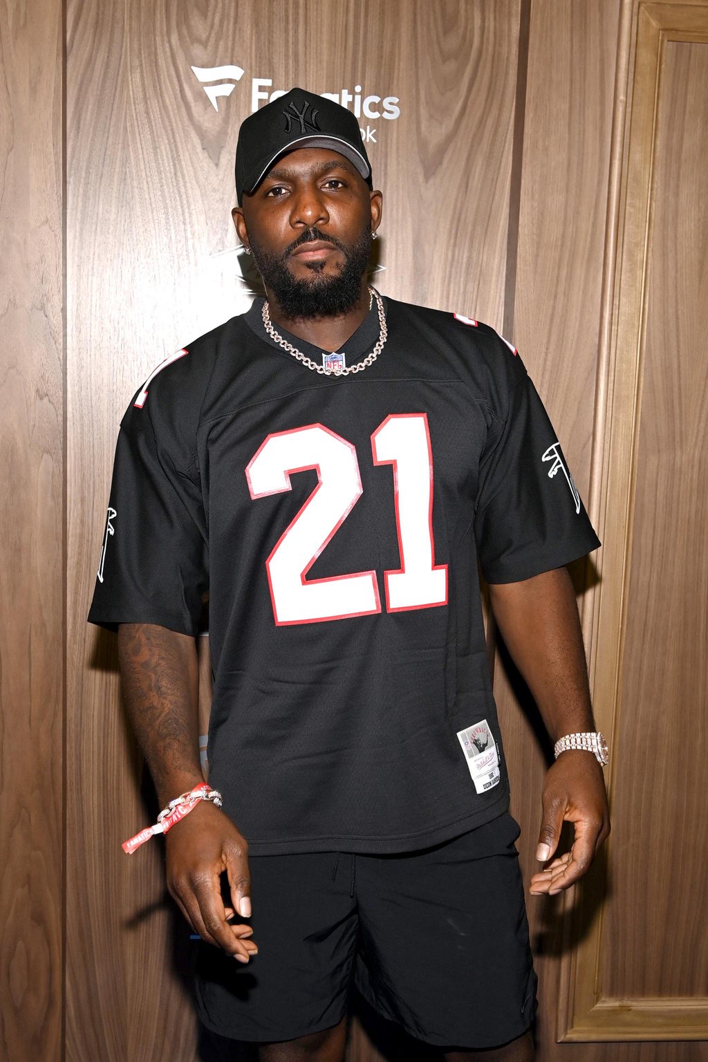 Dez Bryant wearing a black jersey and a baseball cap.