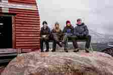Denmarks's King Frederick X, Queen Mary, Princess Josephine and Prince Vincent pose on a bench during a visit in Qeqertarsuaq in Greenland,
