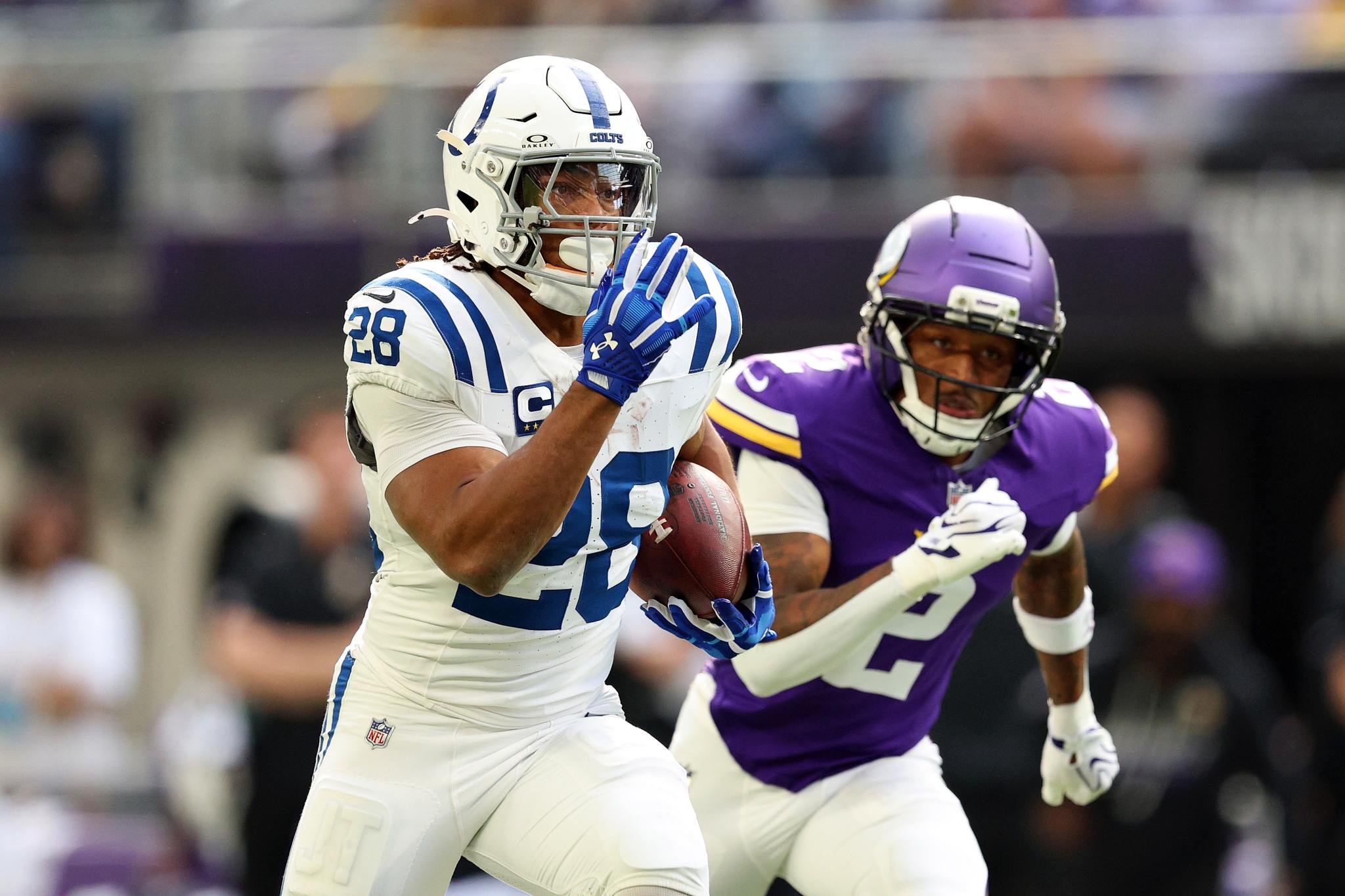 Jonathan Taylor (28) of the Indianapolis Colts runs with the ball past Isaiah Rodgers (2) of the Minnesota Vikings to score a touchdown in the first quarter of an NFL football game at U.S. Bank Stadium in Minneapolis, Sunday, Oct. 25, 2026.