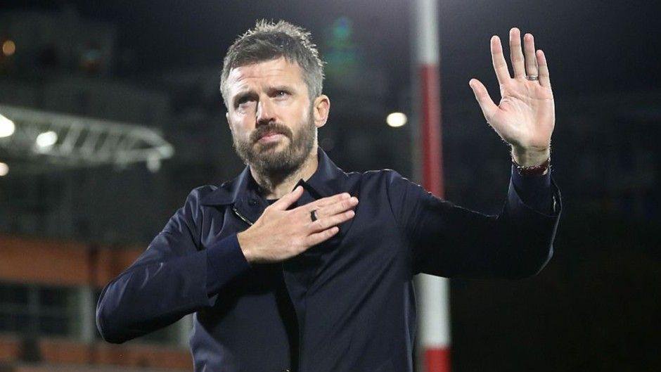 Manchester United head coach Michael Carrick holding up his hands in apology following Manchester United's 4-1 defeat in Como.