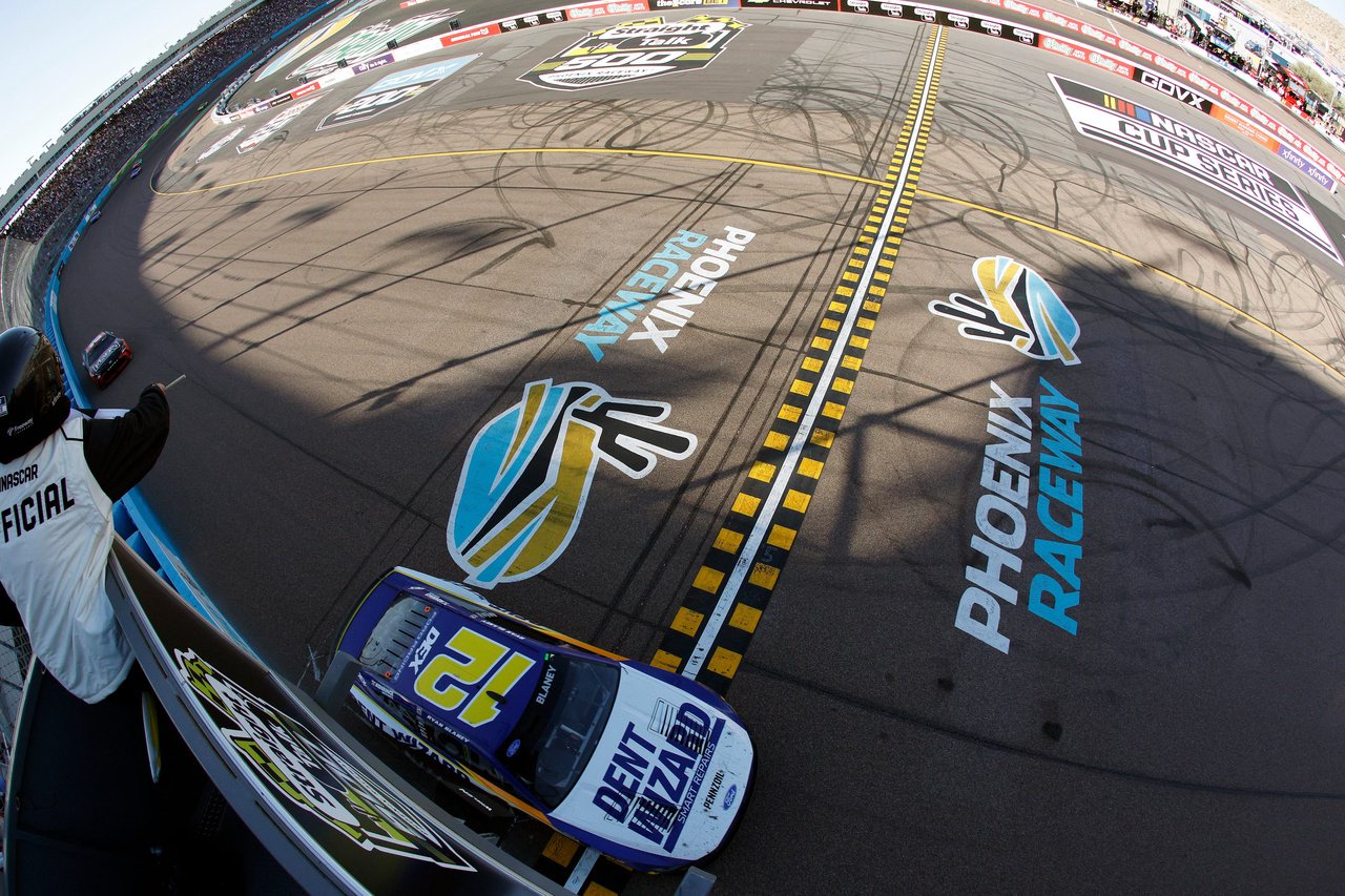 AVONDALE, ARIZONA - MARCH 08: Ryan Blaney, driver of the #12 Dent Wizard Ford, crosses the finish line to win the NASCAR Cup Series Straight Talk Wireless 500 at Phoenix Raceway on March 08, 2026 in Avondale, Arizona. (Photo by Sean Gardner/Getty Images)