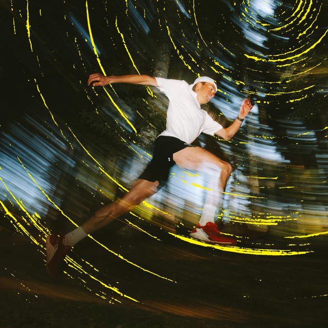 A runner in motion surrounded by a swirling blur of light and color in a forest setting.