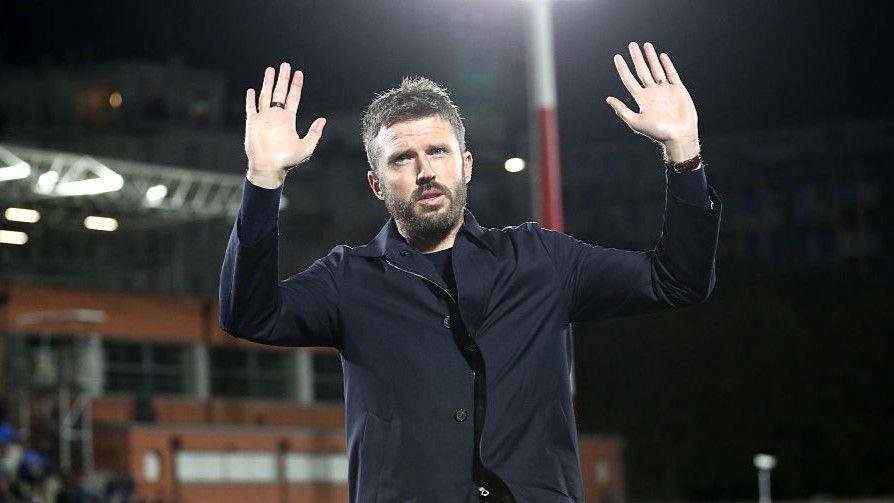 Manchester United head coach Michael Carrick acknowledges the club's fans after the 4-1 defeat by Como