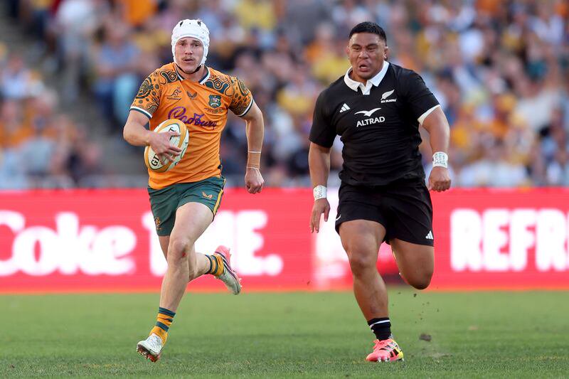 Australia outhalf Declan Meredith makes a break during the Bledisloe Cup match against New Zealand. Photograph: Mark Metcalfe/Getty Images