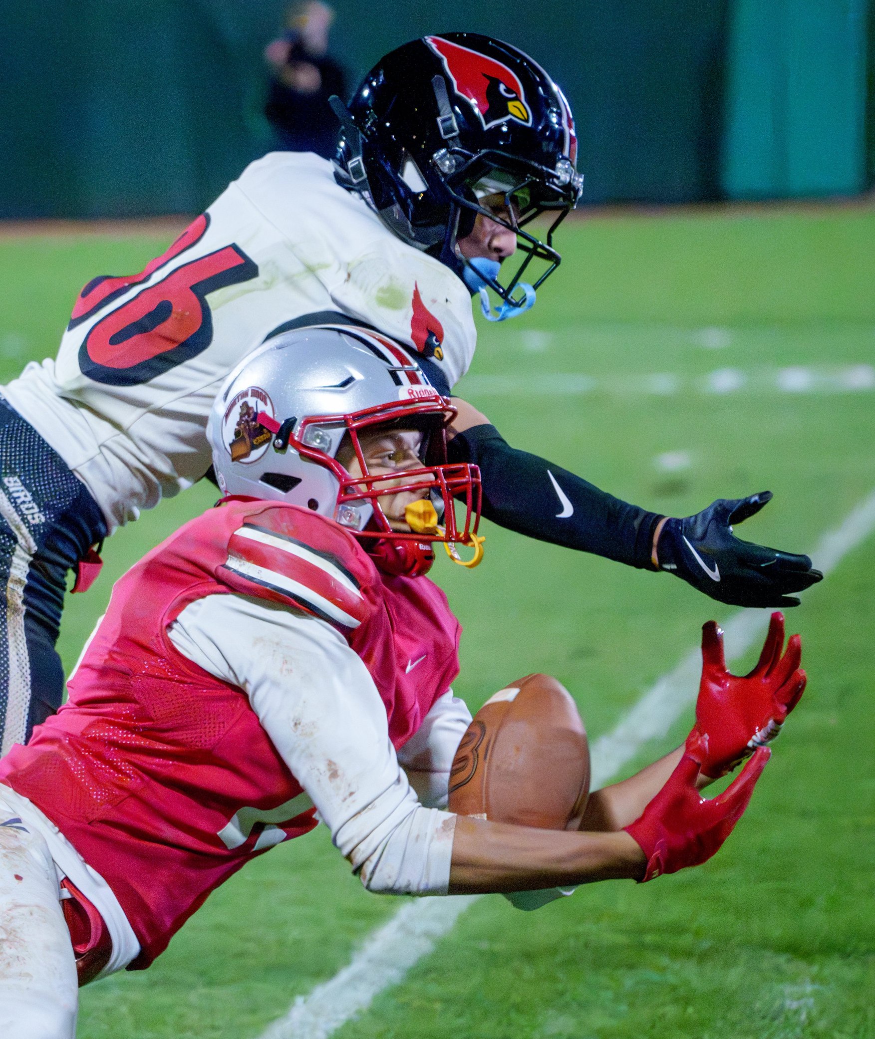 Morton’s Brendan Petty makes a tough catch on Metamora defender Brady Karch in the second half of their Week 9 high school football game Friday, Oct. 16, 2026 at Dozer Park in Peoria. The reception was called back on a penalty, but the Potters defeated the Redbirds 35-7.