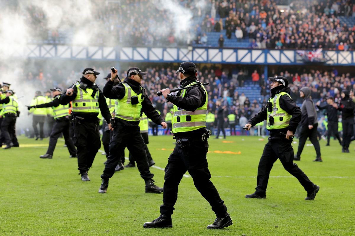 Police react as fans invade the Ibrox pitch