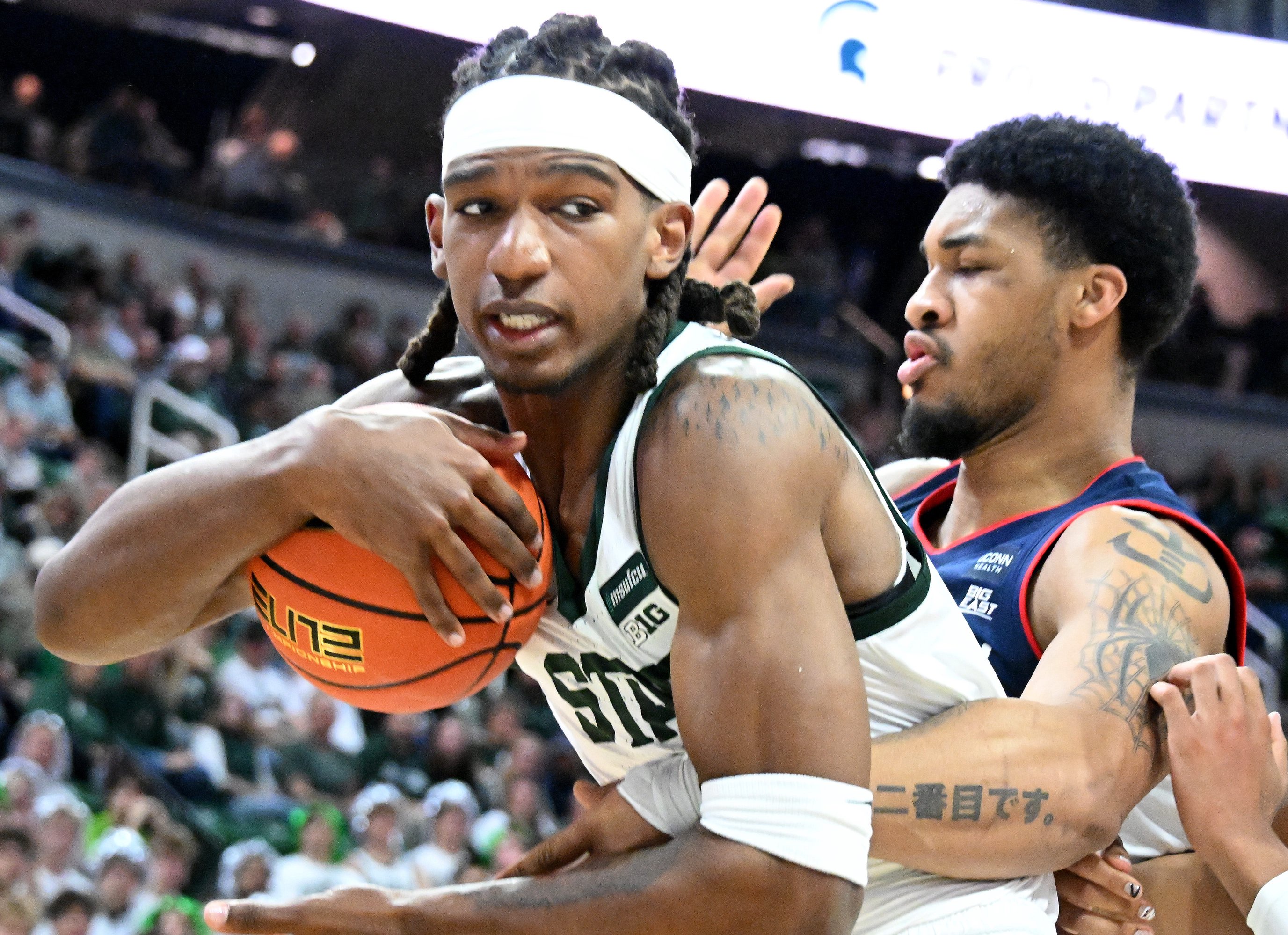 Oct 20, 2026; East Lansing, MI, USA; Michigan State Spartans center Ethan Taylor (10) takes a rebound away from UConn Huskies center Na'jai Hines (9) during the first half at Breslin Center.