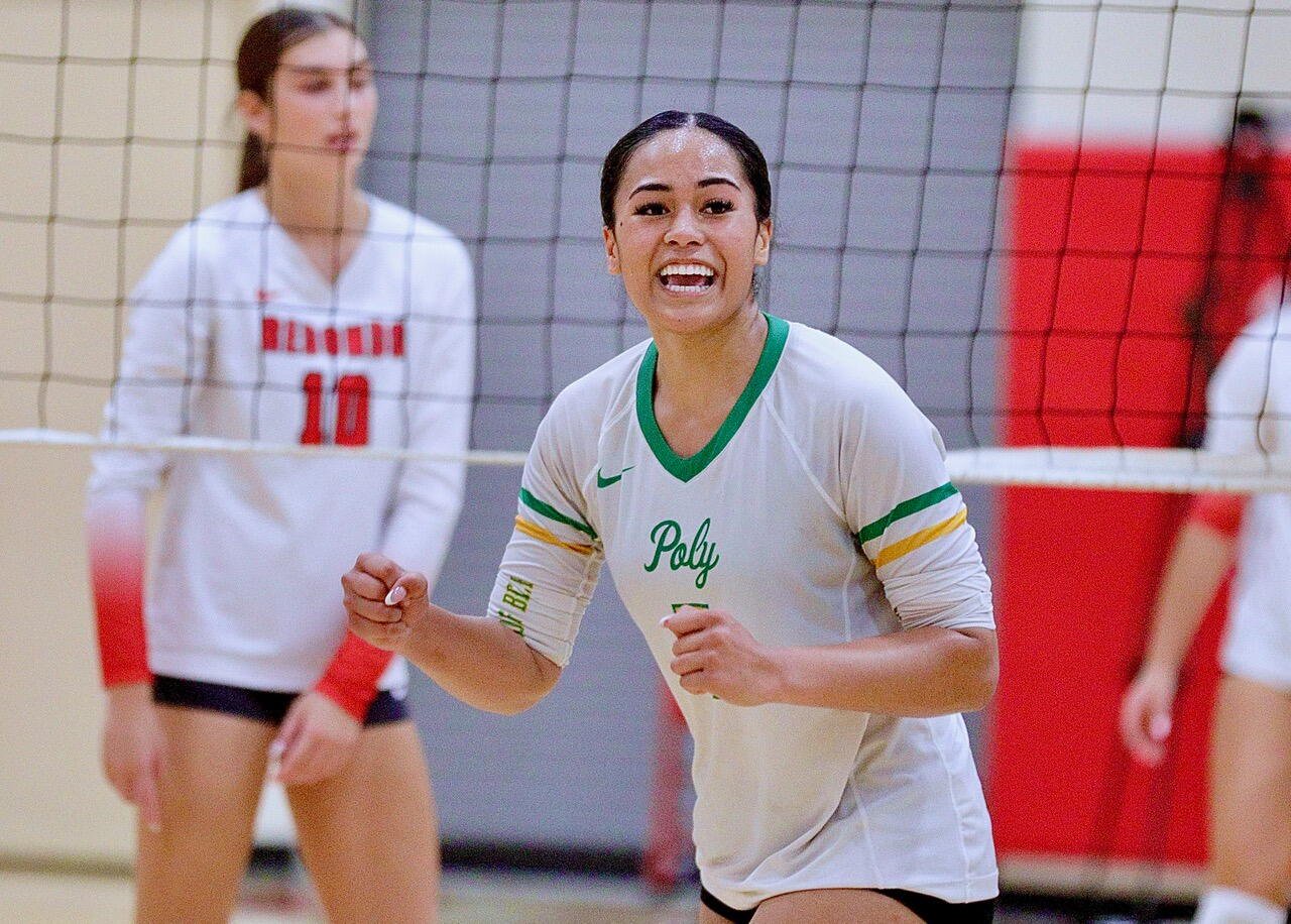 Long Beach Poly High senior McKennah Iamaleava pumps both her fists as she celebrates winning a point against Redondo Union.