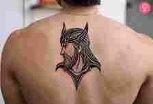A man wearing a Thor tattoo on his back