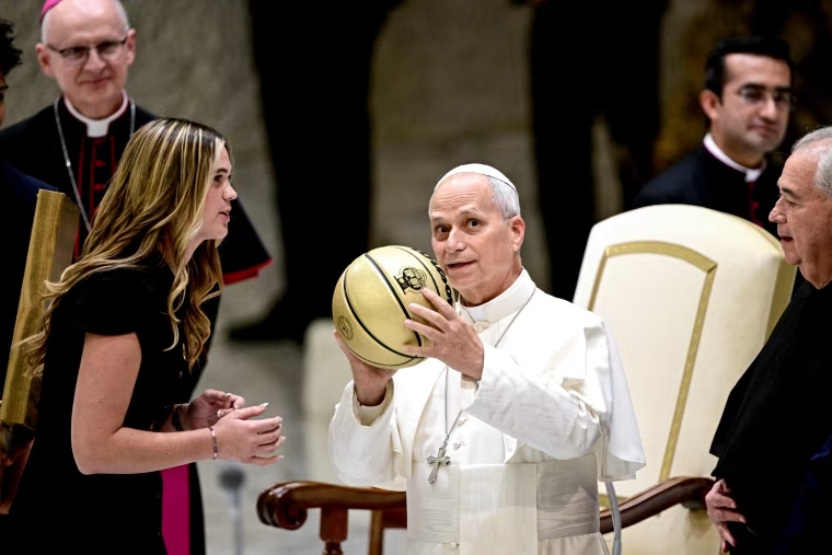 Pope Leo XIV receives a ball as a gift.