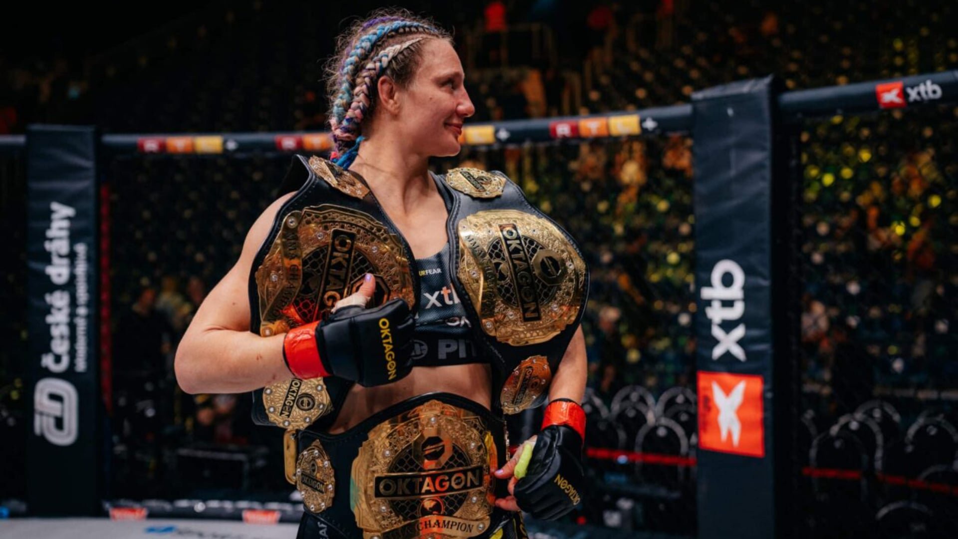Lucia Szabova poses with her Oktagon MMA titles after defending the bantamweight belt against Lucie Pudilova