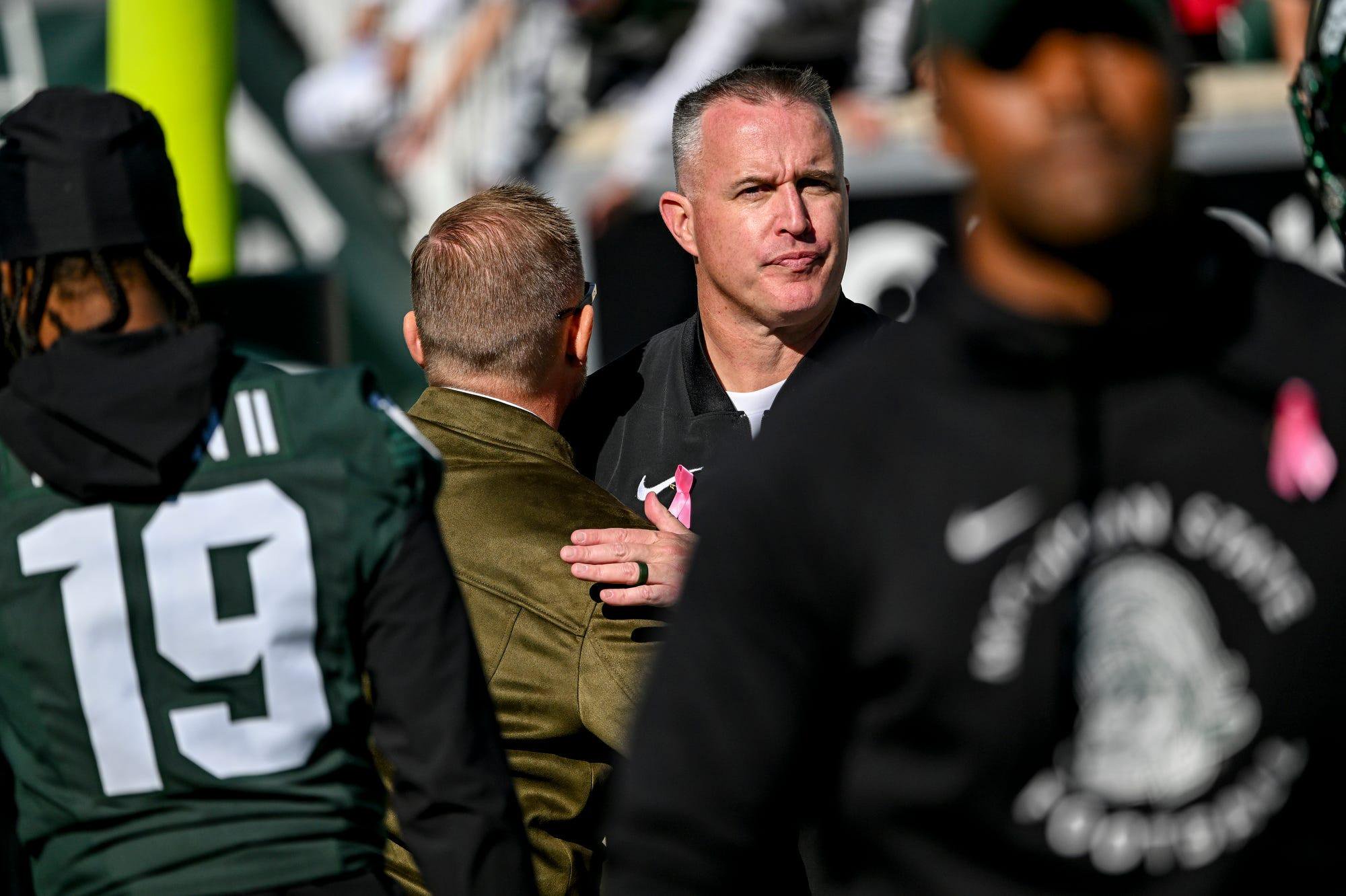 Pat Fitzgerald hugs athletic director Dan Bartholomae after a game.