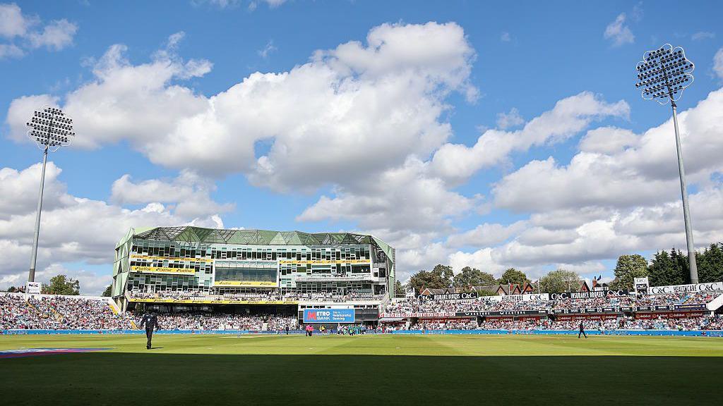 Headingley Cricket Ground with the pavilion in the centre and floodlights either side.
