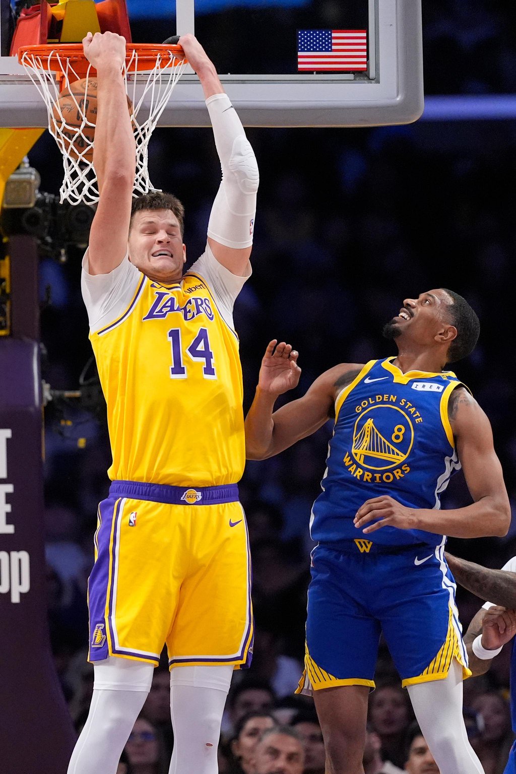 Los Angeles Lakers center Walker Kessler dunks as Golden State Warriors guard De'anthony Melton defends.