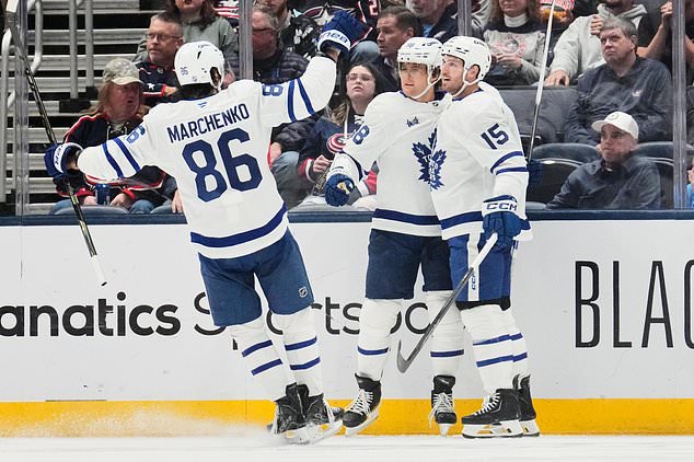 Toronto Maple Leafs right wing William Nylander, center, celebrates his goal with Kirill Marchenko (86) and Colton Sissons (15) in the second period of an NHL hockey game against the Columbus Blue Jackets, in Columbus, Ohio, Tuesday, October. 20, 2026. (AP Photo/Sue Ogrocki)