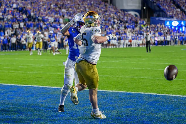 The ball is deflected away by BYU linebacker Isaiah Glasker, center rear, intended for Notre Dame tight end Jack Larsen, center front, during the second half of an NCAA college football game, Saturday, Oct. 17, 2026, in Provo, Utah. (AP Photo/Tyler Tate)