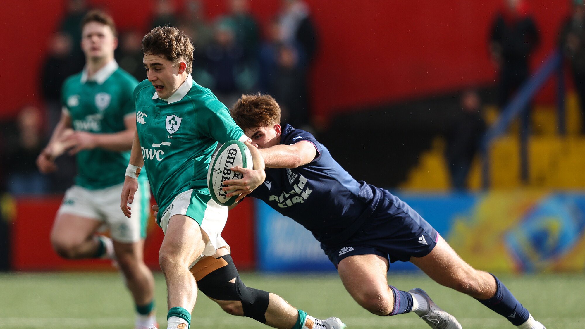Ireland's Christopher Barrett is tackled by Harry Clark of Scotland ©INPHO
