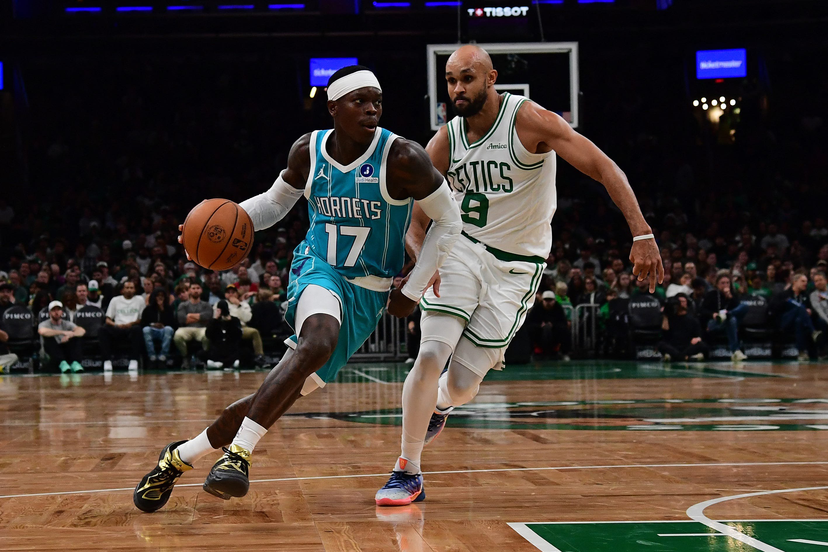Oct 14, 2026; Boston, Massachusetts, USA;  Charlotte Hornets guard Dennis Schroder (17) controls the ball while Boston Celtics guard Derrick White (9) defends during the second half at TD Garden. Mandatory Credit: Bob DeChiara-Imagn Images