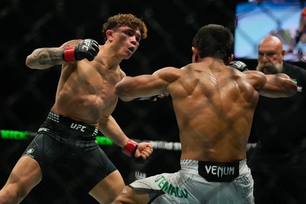 Lone'er Kavanagh punches Ramazan Temirov during a flyweight bout at a UFC Fight Night event.