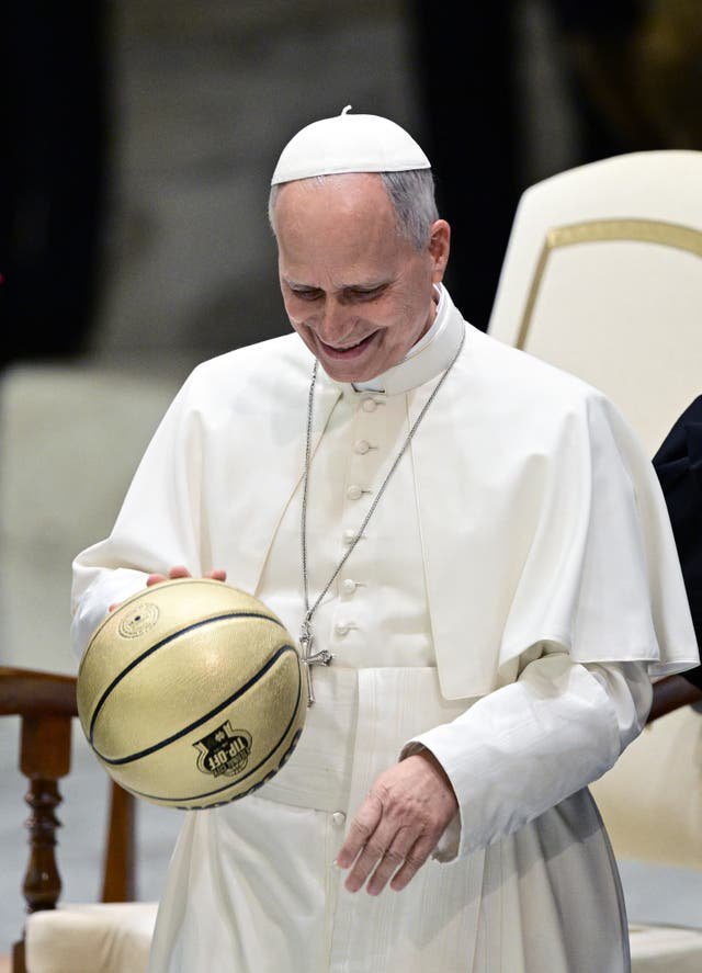 Pope Leo XIV receives a basketball as a gift during an audience with delegations from Villanova University and the University of Notre Dame at the Paul VI Audience Hall in the Vatican on October 31, 2026