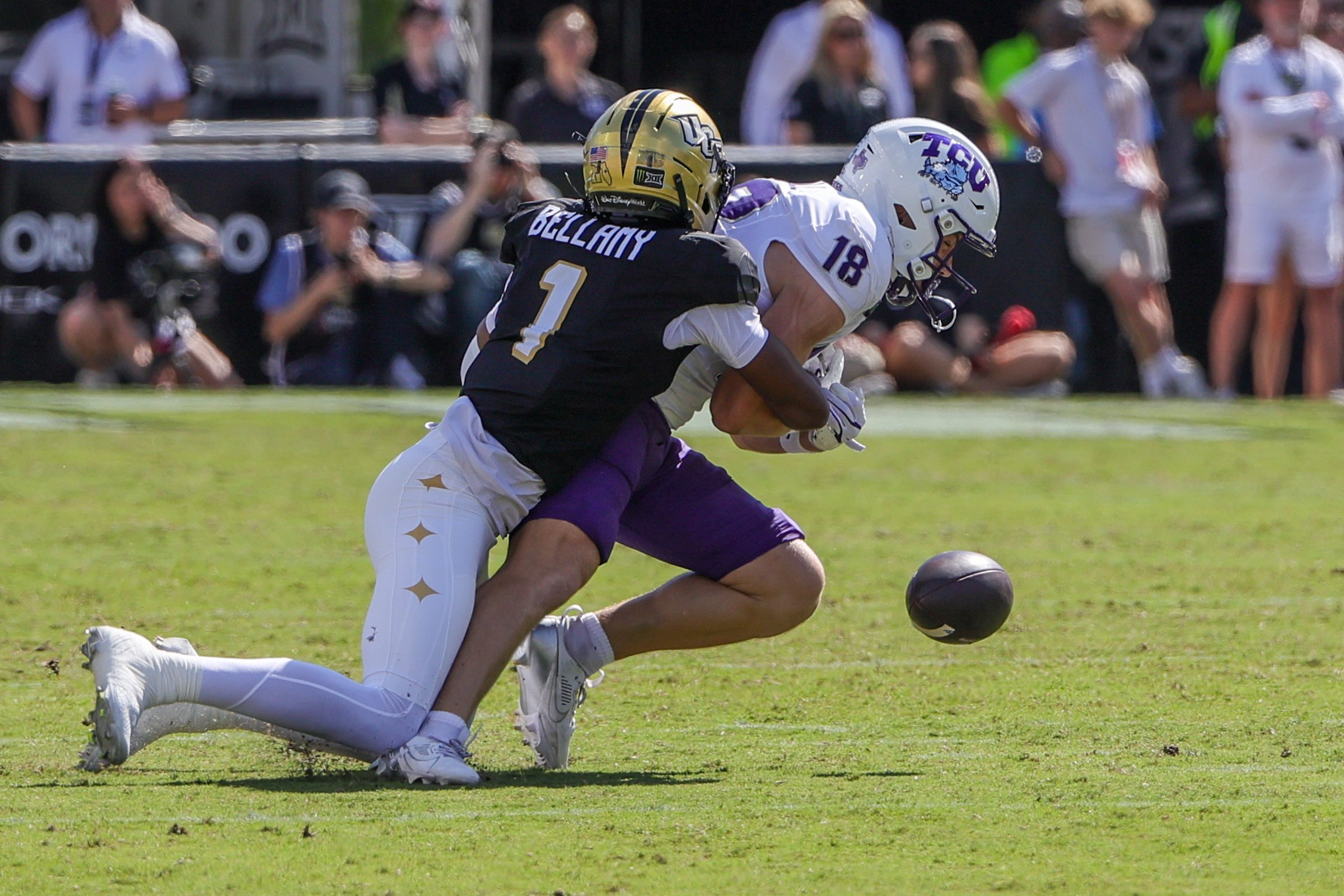 Sep 26, 2026; Orlando, Florida, USA;  TCU Horned Frogs wide receiver Ed Small (18) fumbles as UCF Knights defensive back Jayden Bellamy (1) makes the tackle during the first quarter at Acrisure Bounce House.  Mandatory Credit: Mike Watters-Imagn Images