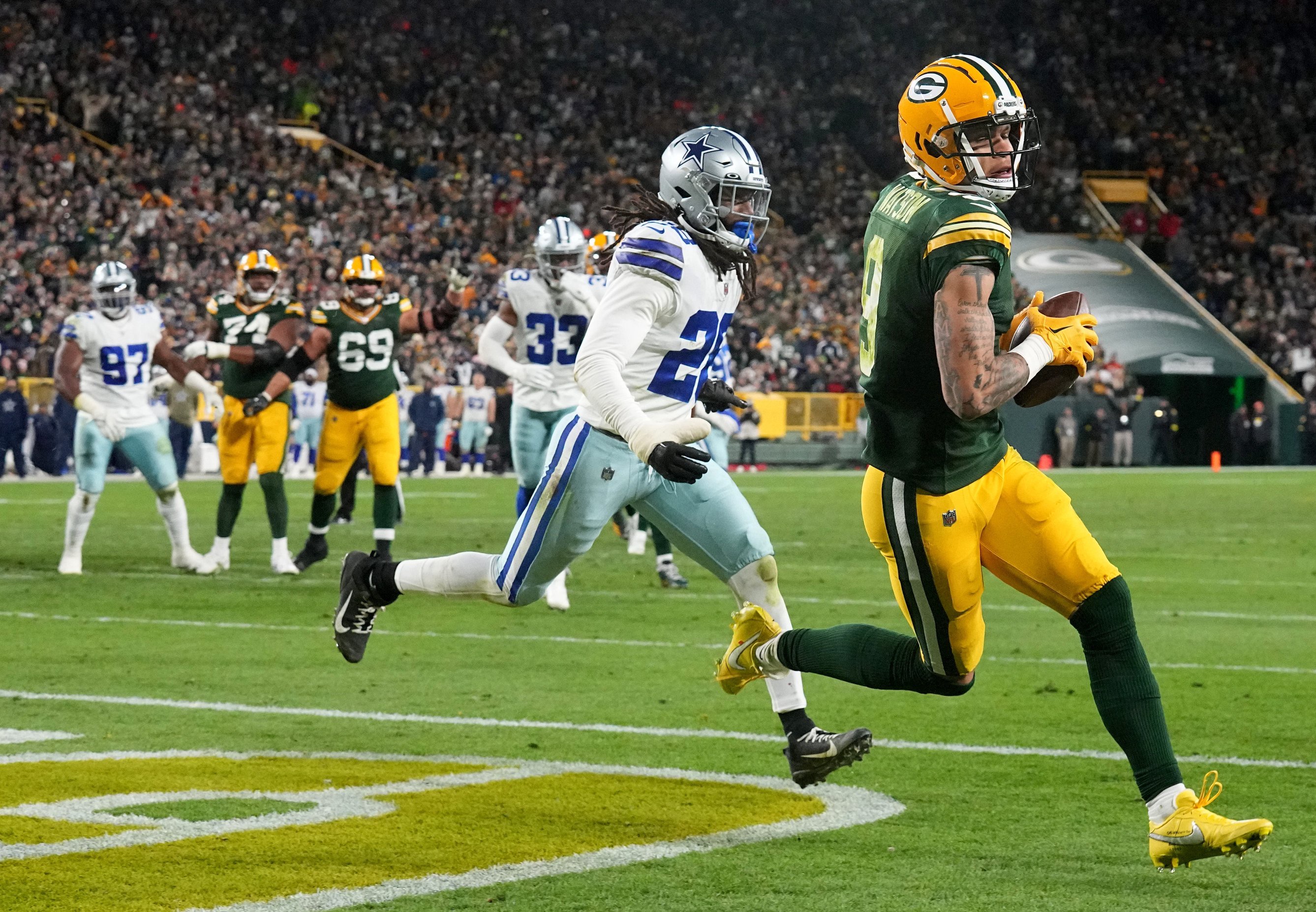 Green Bay Packers wide receiver Christian Watson (9) scores a touchdown on a seven yard reception during the fourth quarter of their game Sunday, November 13, 2022 at Lambeau Field in Green Bay, Wis. The Green Bay Packers beat the Dallas Cowboys 31-28 in overtime.

Packers13 6