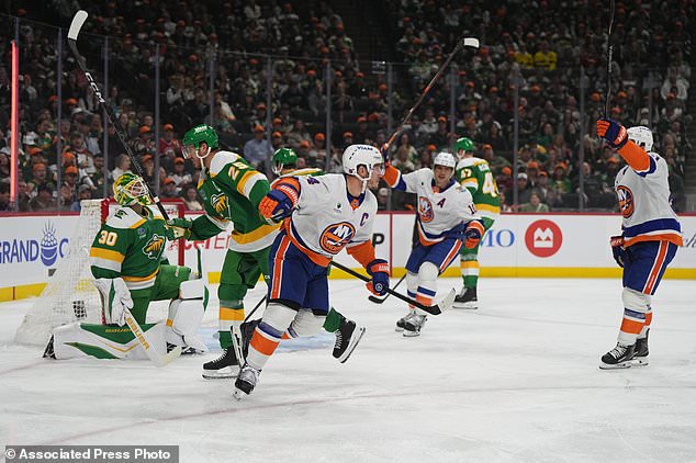 New York Islanders center Bo Horvat, middle, reacts after scoring a goal during the second period of an NHL hockey game against the Minnesota Wild, Thursday, Oct. 29, 2026, in St. Paul, Minn. (AP Photo/Abbie Parr)