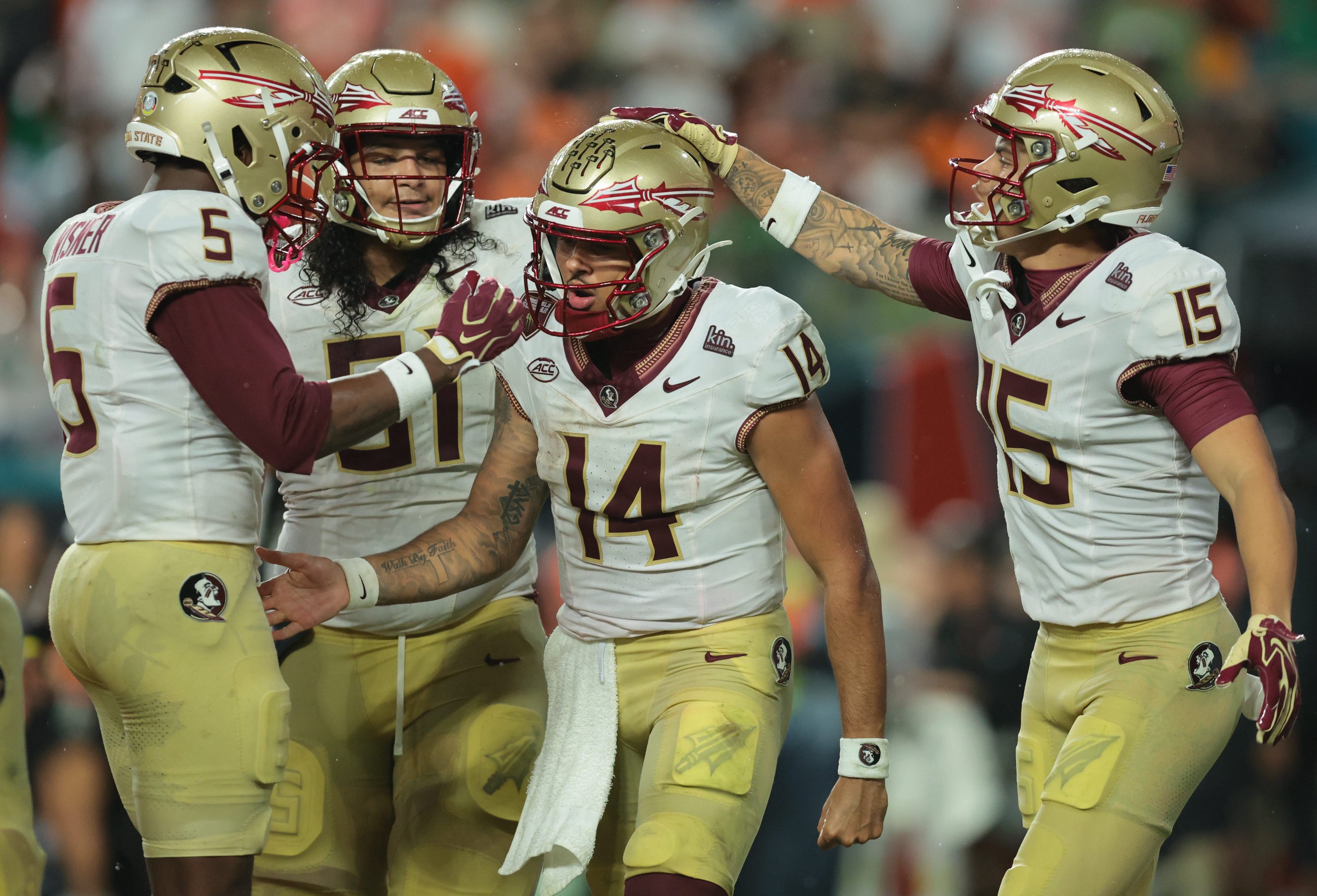 Oct 17, 2026; Miami Gardens, Florida, USA;  Florida State Seminoles quarterback Ashton Daniels (14) celebrates with Florida State Seminoles running back Quintrevion Wisner (5), offensive line Paul Bowling (51) and wide receiver Jayvan Boggs (15) after a touchdown during the second quarter against the Miami Hurricanes at Hard Rock Stadium.  Mandatory Credit: Sam Navarro-Imagn Images