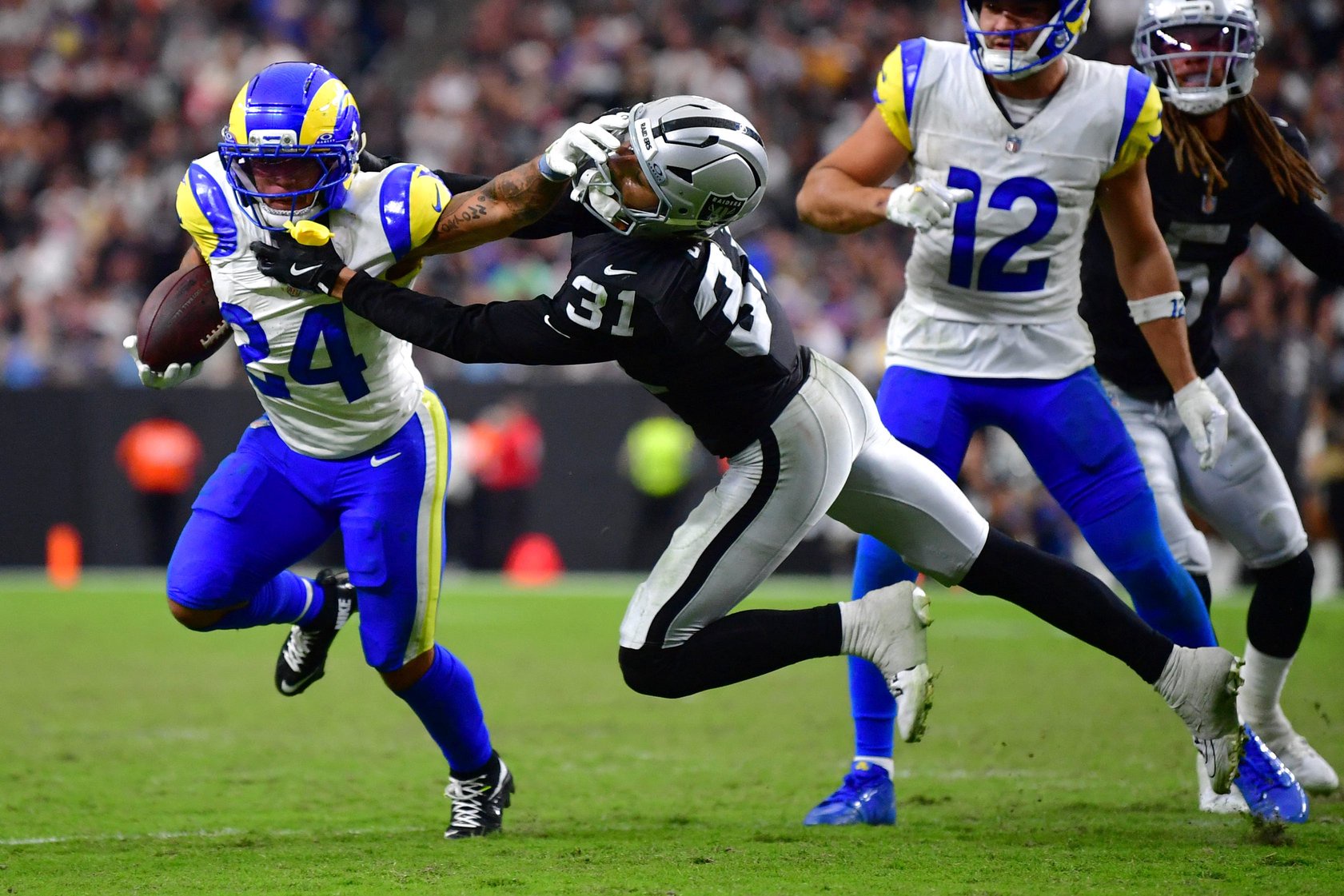Oct 25, 2026; Paradise, Nevada, USA;  Los Angeles Rams running back Blake Corum (24) rushes the ball past Las Vegas Raiders safety Treydan Stukes (31) at Allegiant Stadium.  Mandatory Credit: Gary A. Vasquez-Imagn Images