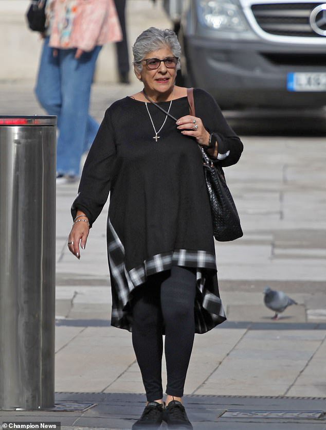 The couple's neighbour Andrianna Neophytou, also seen leaving the court, has branded the structure in Coulsdon, south London, an 'eyesore' and wants it demolished