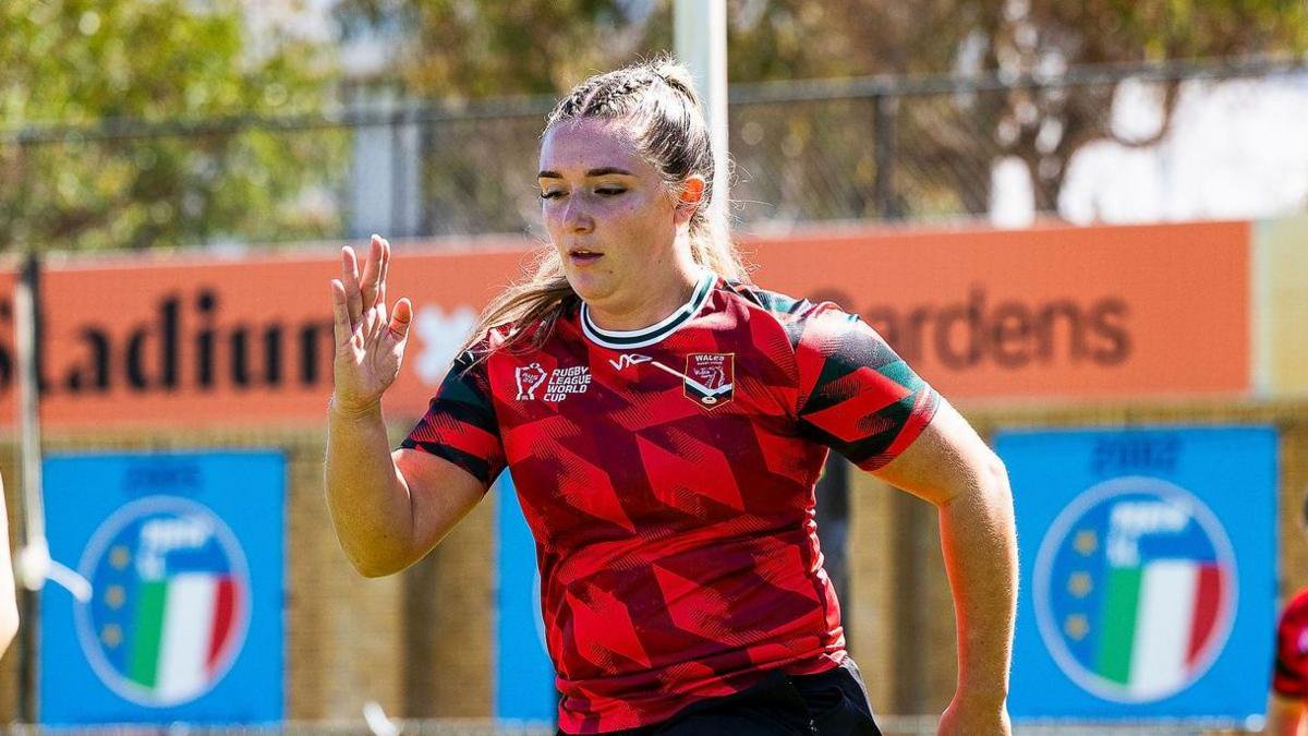 Erin Williams in red top runs during training