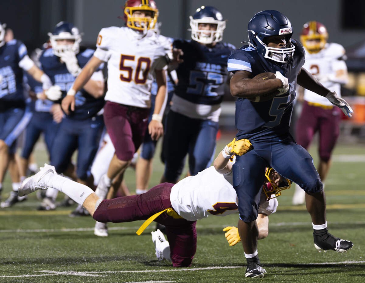 Olympia running back Ibrahima Diallo (5) runs in a touchdown losing Capital's Carter Armstrong (4) on the way during the first half of the game at Ingersoll Stadium, on Friday, Sept. 4, 2026, in Olympia.