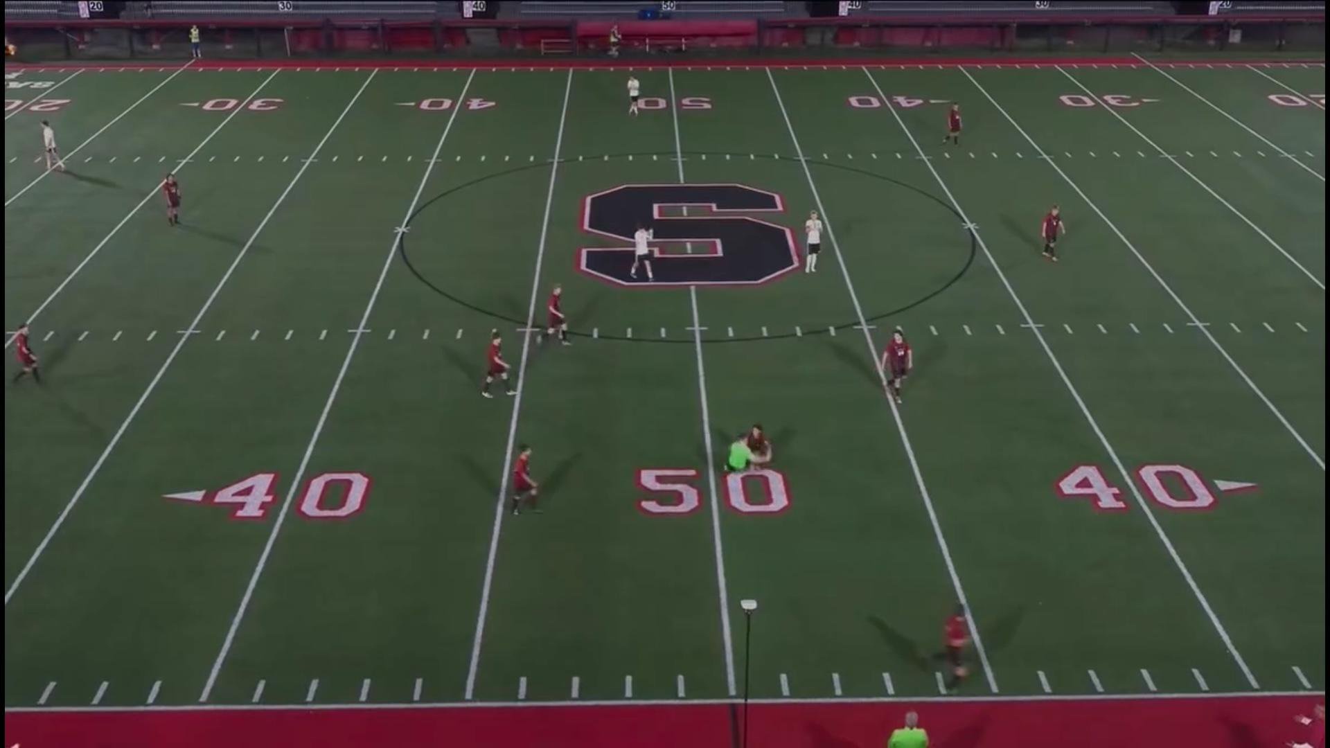 Soccer players spread across a field with the letter S at midfield.