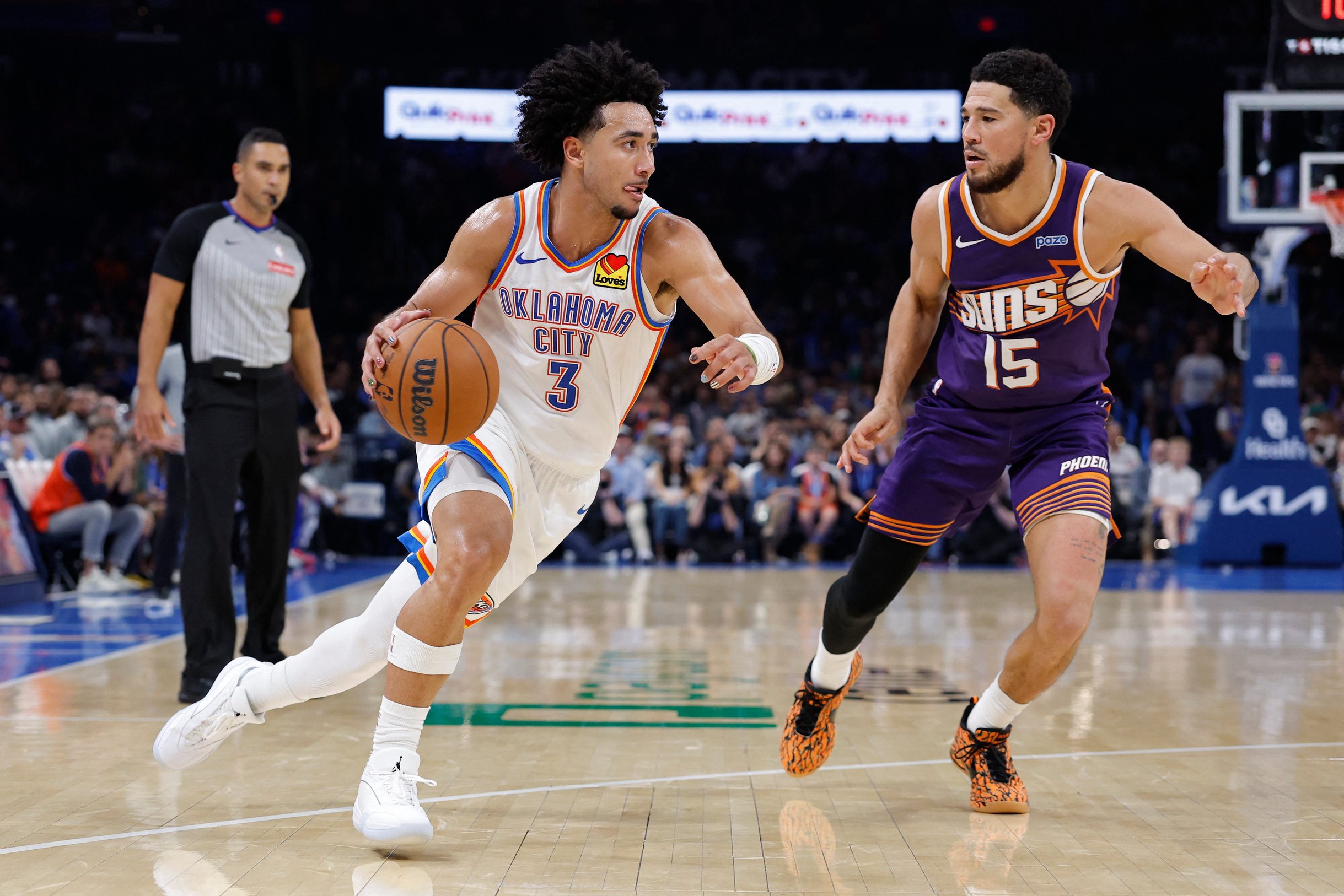 Oct 26, 2026; Oklahoma City, Oklahoma, USA; Oklahoma City Thunder guard Jared McCain (3) drives by Phoenix Suns guard Devin Booker (15) during the second half at Paycom Center. Mandatory Credit: Alonzo Adams-Imagn Images