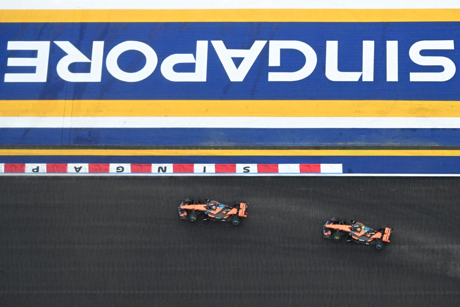 McLaren driver Oscar Piastri leads teammate Lando Norris on track during the F1 Sprint at the 2026 Singapore Grand Prix