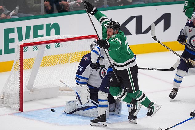 Dallas Stars center Roope Hintz (24) jumps after scoring a goal against Winnipeg Jets goaltender Stuart Skinner (74) during the third period of an NHL hockey game Thursday, Oct. 22, 2026, in Dallas. (AP Photo/LM Otero)