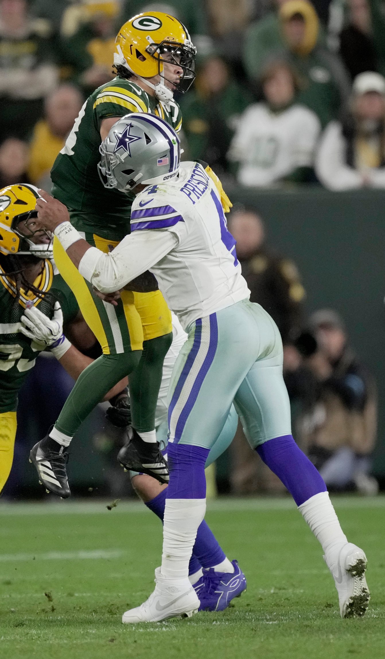 Green Bay Packers safety Evan Williams (33) hits Dallas Cowboys quarterback Dak Prescott (4) and is called for roughing the passer during the fourth quarter of their game Sunday, Oct. 18, 2026 at Lambeau Field in Green Bay, Wisconsin. 