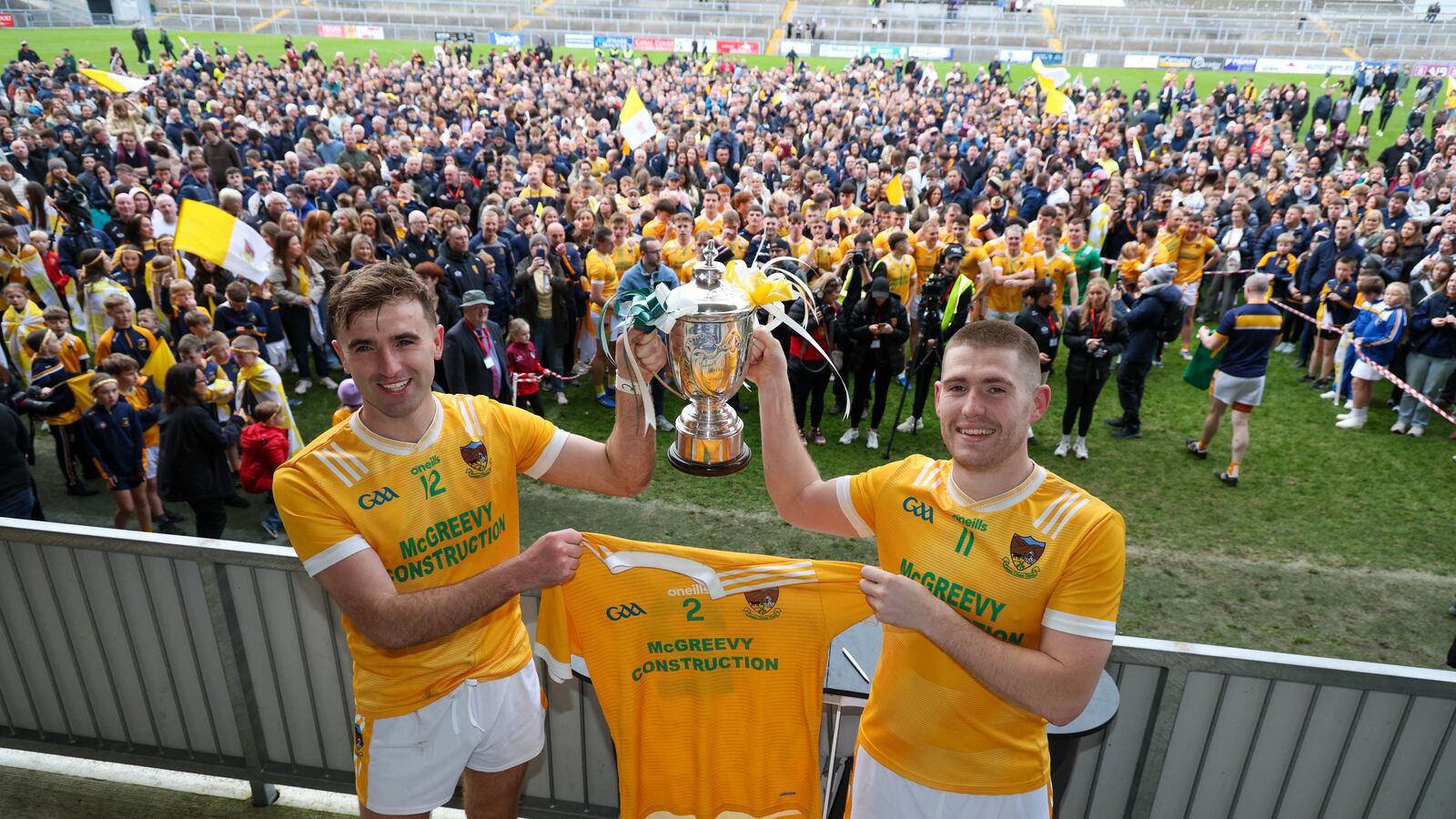 Charlie Carr and Stephen McConville lift the Frank O'Hare Cup after beating Burren in the Down Senior Championship Final on Sunday.
