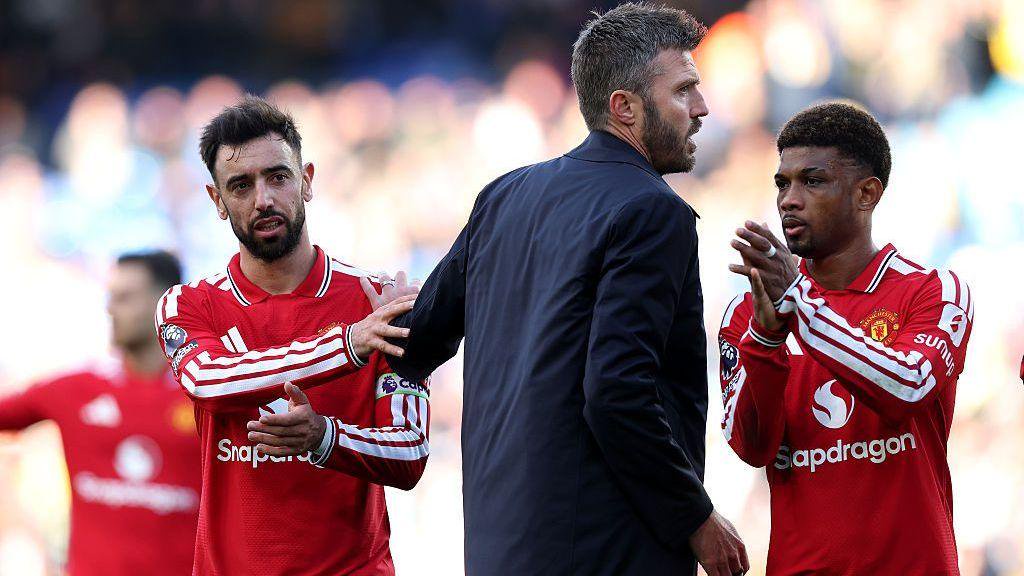 Manchester United boss Michael Carrick interacts with his captain Bruno Fernandes
