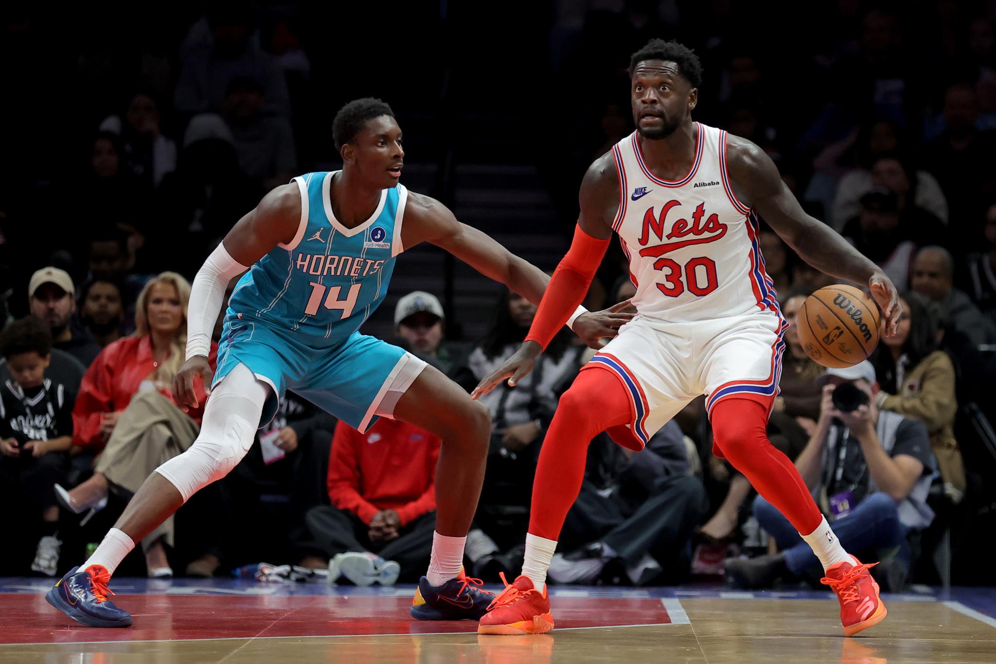 Brooklyn Nets forward Julius Randle (30) controls the ball against Charlotte Hornets forward Moussa Diabate (14) during a game at Barclays Center.