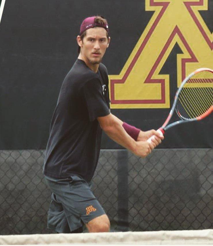 Tennis player Stefan Milicevic on the court holding a racket.