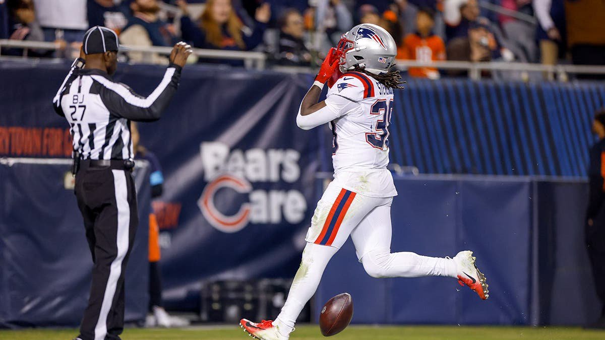 Rhamondre Stevenson celebrates after scoring a touchdown at Soldier Field.